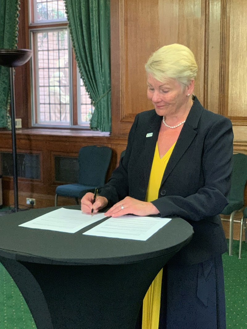 Caroline Gumble signing the joint institutes MoU on EDI