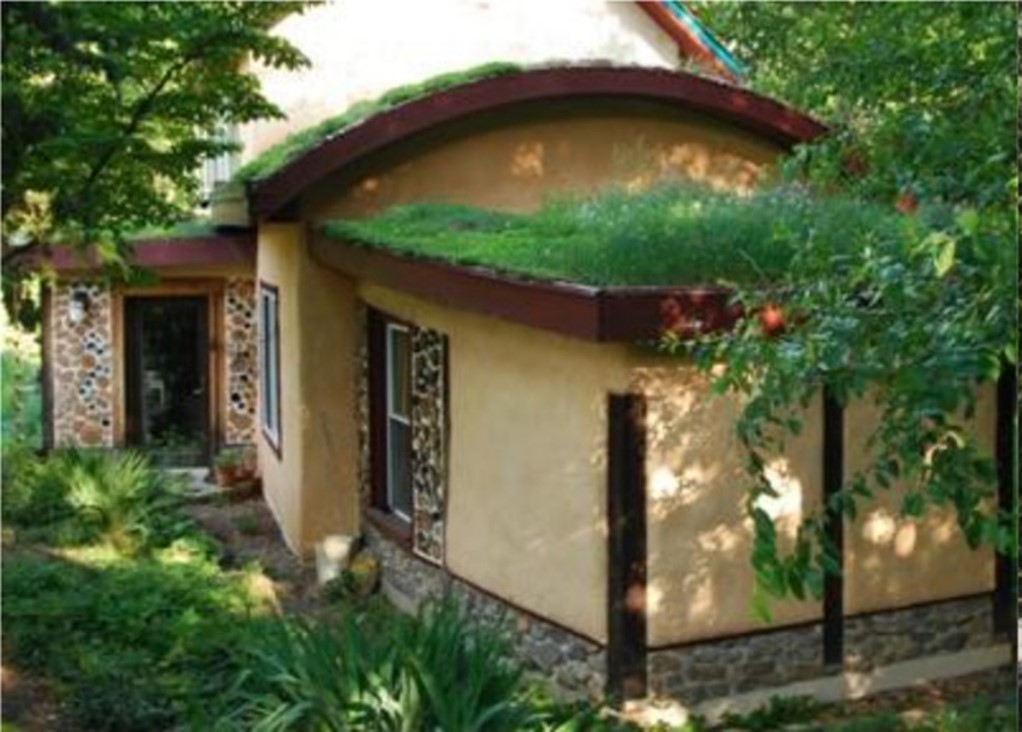 Figure 7: A 540m2 house covered with cob plaster and cordwood by Down to Earth Design